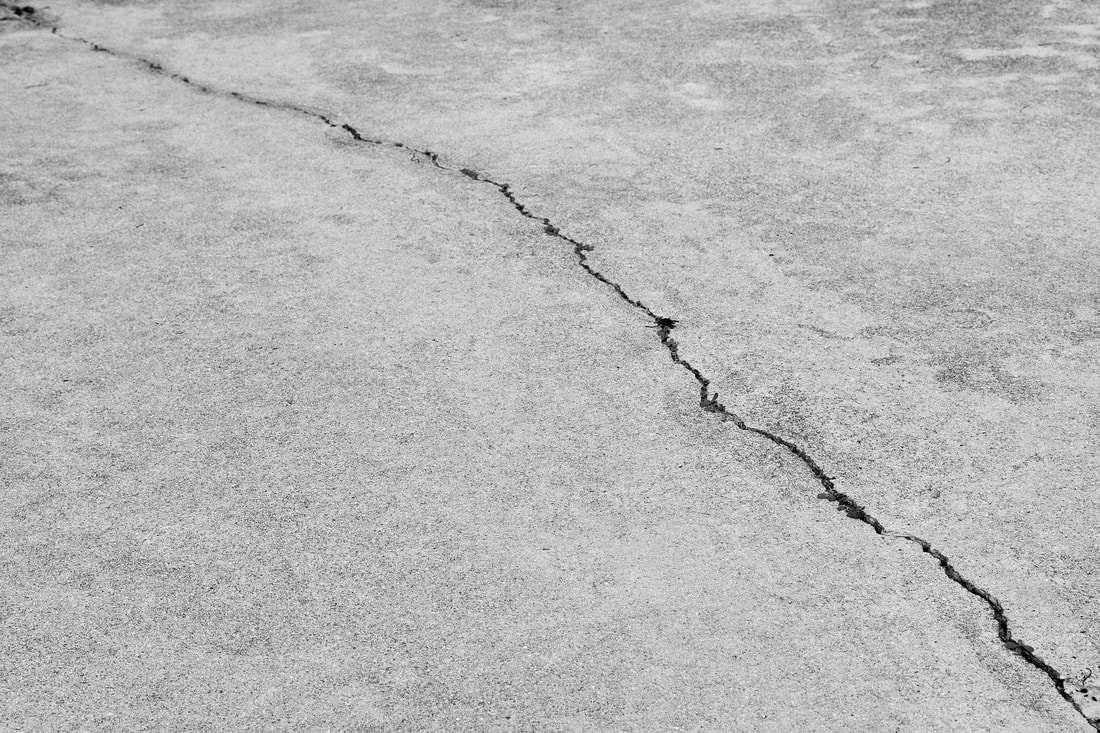 This is a photo of a crack in someone concrete. Surrey concrete contractors were quick to repair this crack.
