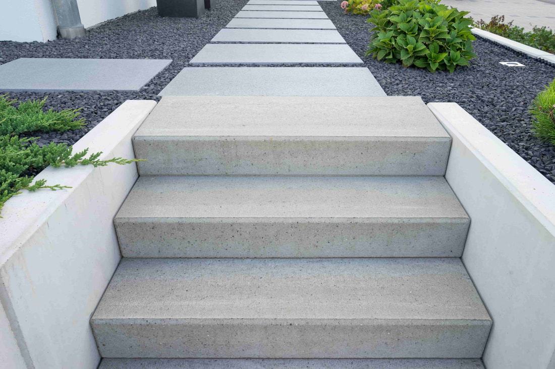 This photo shows a concrete stair case that is a modern design. This home is based in Surrey.