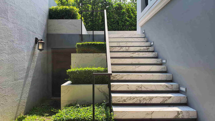 This concrete stair set was stained to look like marble. This photo shows how decorative concrete is used in Surrey.